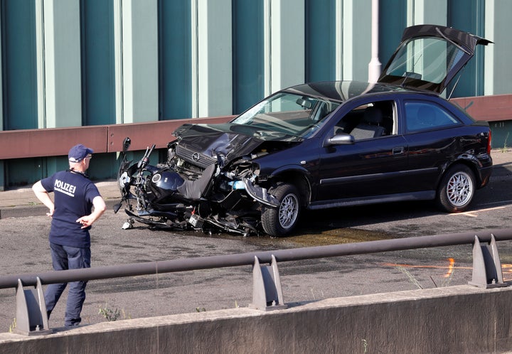 A police officer investigates the scene of a series of allegedly deliberate car crashes on highway A100 in Berlin, Germany, August 19.