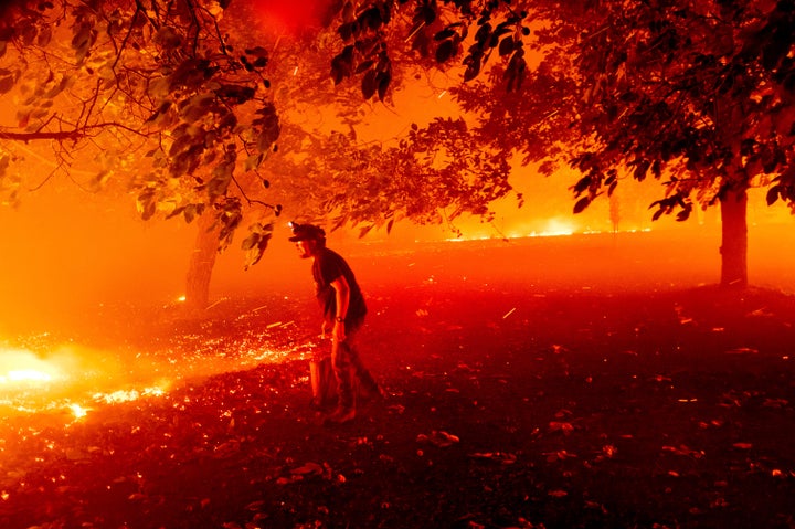 California resident Matt Nichols tries to save his home as the LNU Lightning Complex fires tear through Vacaville on Wednesday.