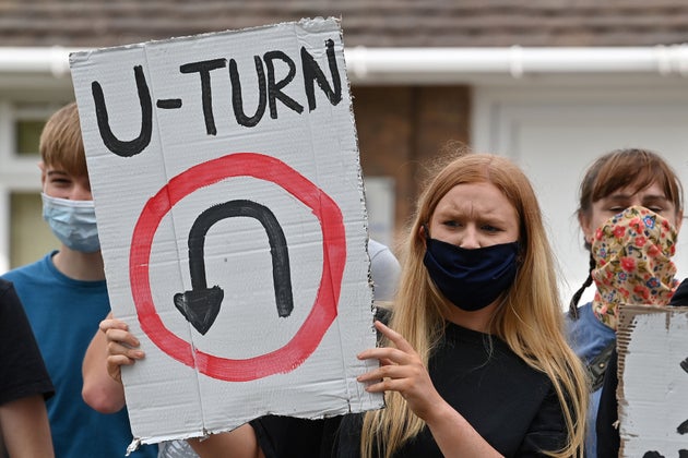 A student holds a placard reading