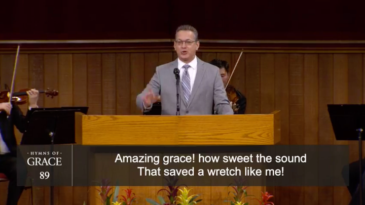 A musical minister at Grace Community Church leads the congregation in a hymn on Aug. 16.