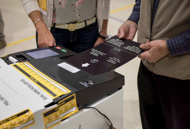 A voter uses an electronic voting machine to cast their ballot in the New Brunswick provincial election at a voting station in Dieppe, N.B., on Sept. 24, 2018.