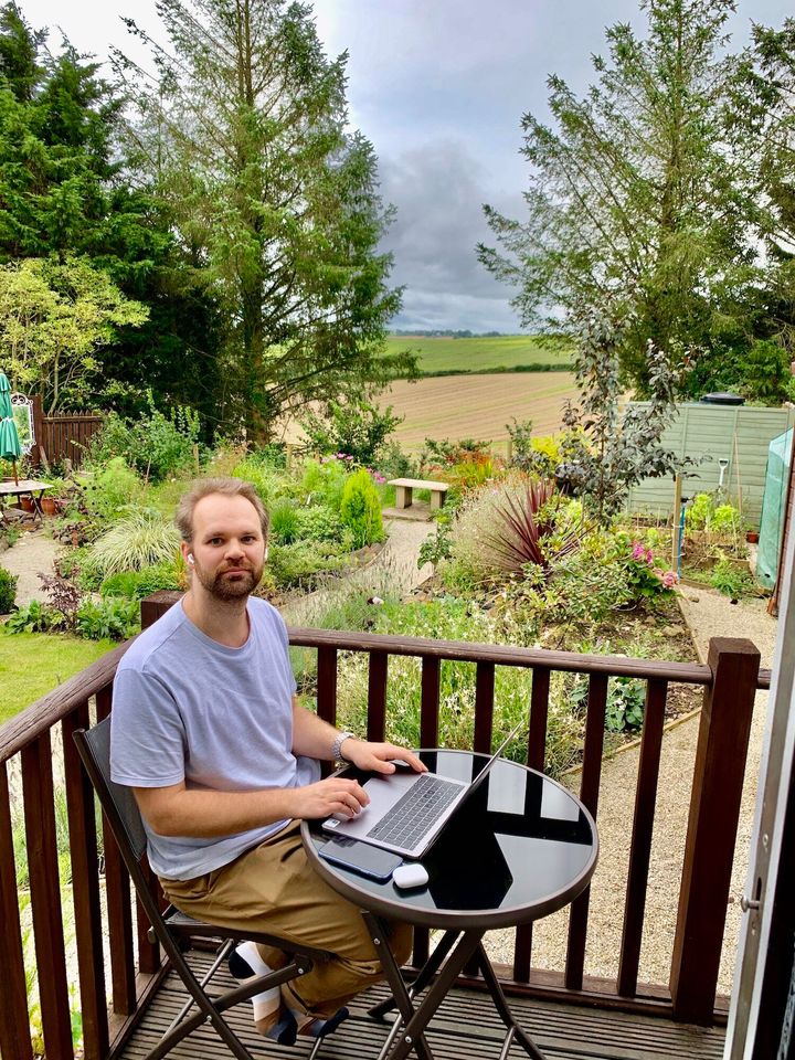 Konrad working from the garden of their Airbnb.