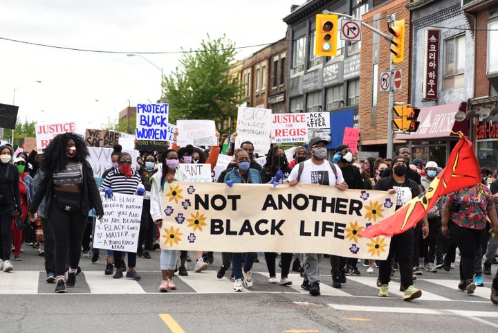 Protesters in Toronto march during a rally to protest racism and police brutality on May 30, 2020.