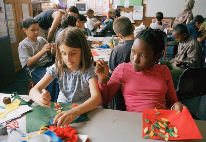 Children learning to sew at Millfields Community School in London, U.K.