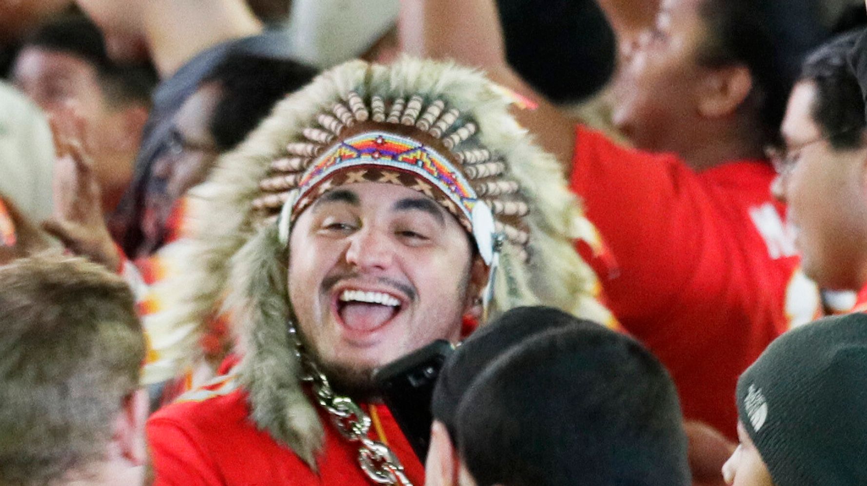 Kansas City Chiefs fans wear rain gear before an NFL football game