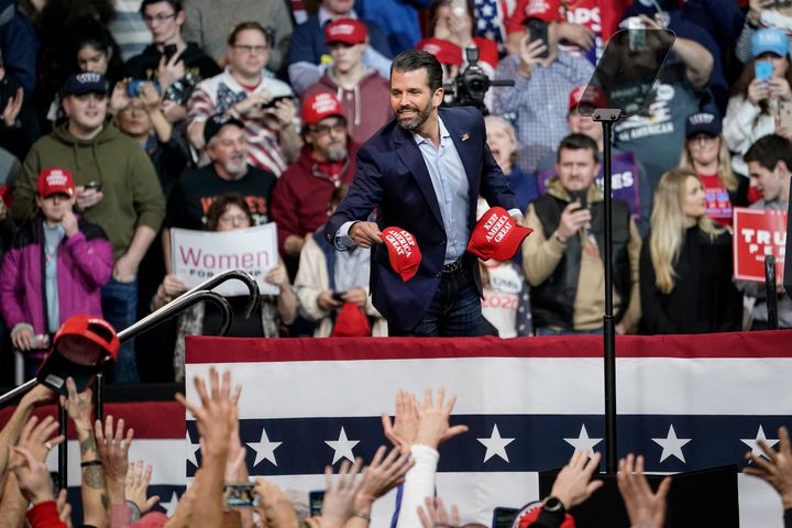 Donald Trump Jr. tosses hats into the crowd during a rally at Southern New Hampshire University Arena on Feb. 10 in Manchester, New Hampshire.