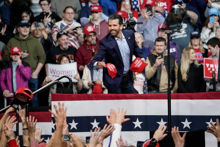 Donald Trump Jr. tosses hats into the crowd during a rally at Southern New Hampshire University Arena on Feb. 10 in Manchester, New Hampshire.