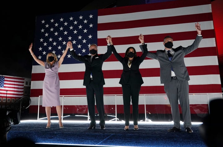 Jill Biden, presidential nominee Joe Biden, vice presidential nominee Kamala Harris and her husband, Douglas Emhoff, greet supporters in Wilmington, Delaware, on Thursday.