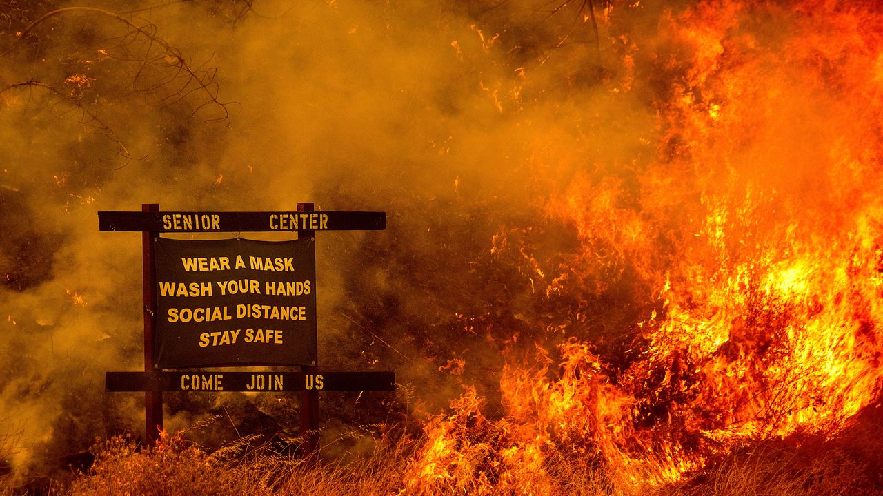 Flames from the LNU Lightning Complex fires spread in unincorporated Napa County, California, on Tuesday. The blaze destroyed multiple homes near Lake Berryessa. Fire crews across the region scrambled to contain dozens of wildfires sparked by lightning strikes during a statewide heatwave.