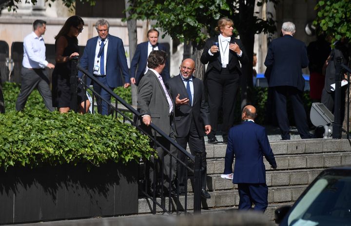 MPs as they are seen queuing in a courtyard on the parliamentary estate to vote.