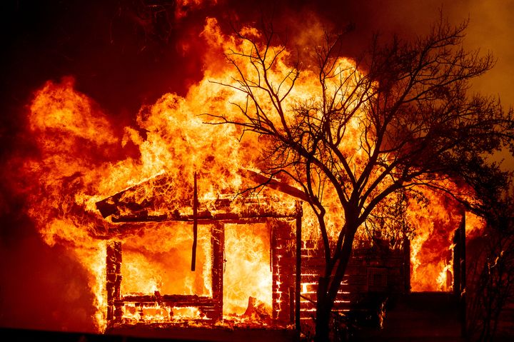 A home is destroyed Wednesday in Vacaville, California. Fire crews across the region scrambled to contain dozens of wildfires sparked by lightning strikes as a statewide heat wave continues.