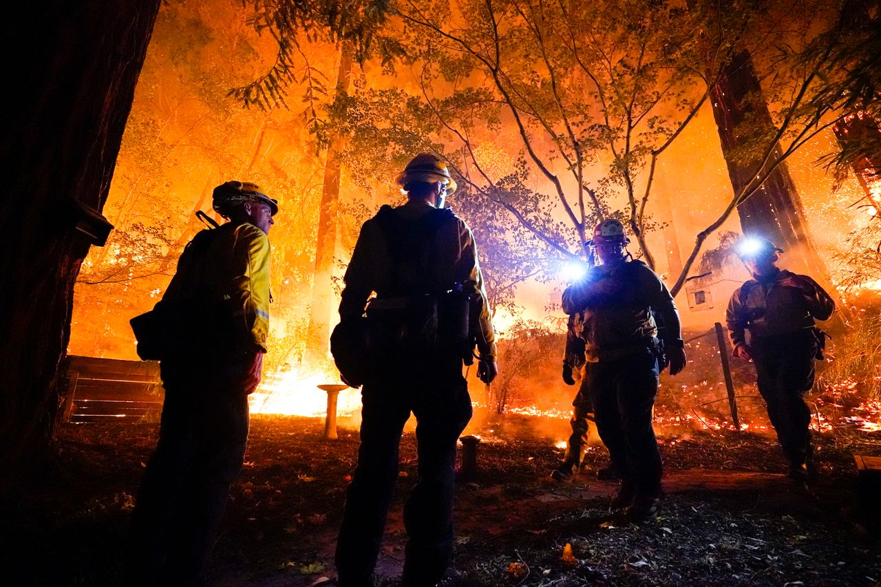 Firefighters make a stand in the backyard of a home in Boulder Creek, California.