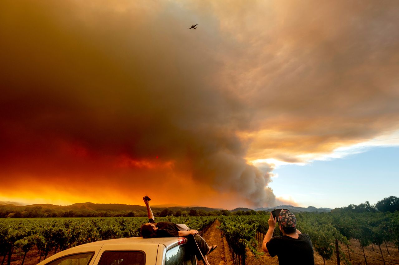 Thomas Henney, left, and Charles Chavira watch a plume spread over Healdsburg, California.