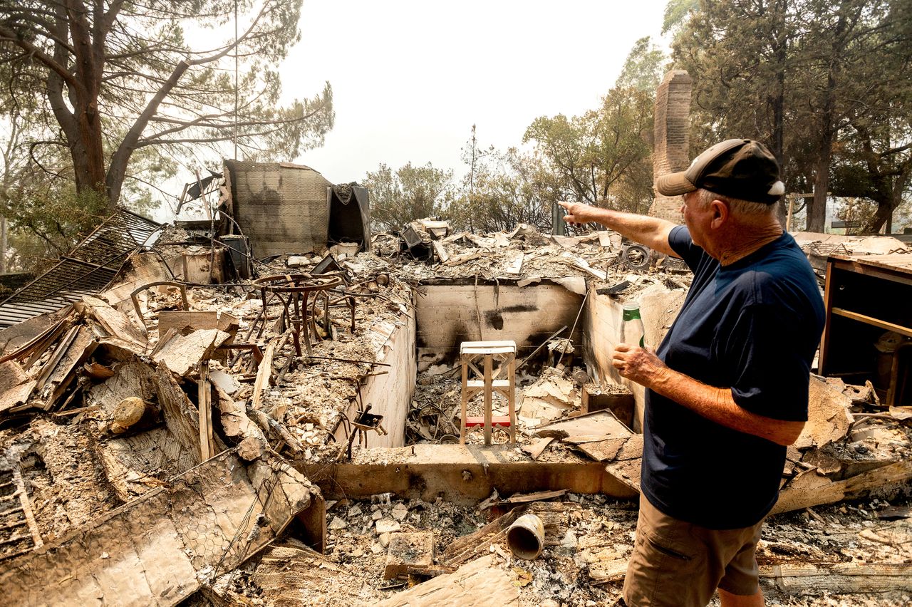Hank Hanson, 81, gestures to the kitchen of his home, destroyed by the LNU Lightning Complex fires, in Vacaville, California.