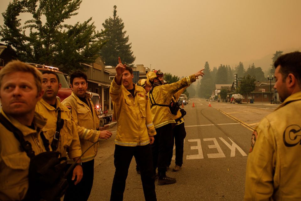 Volunteer firefighters for the Boulder Creek Fire District are joined by reinforcements from other California fire departments in Boulder Creek.