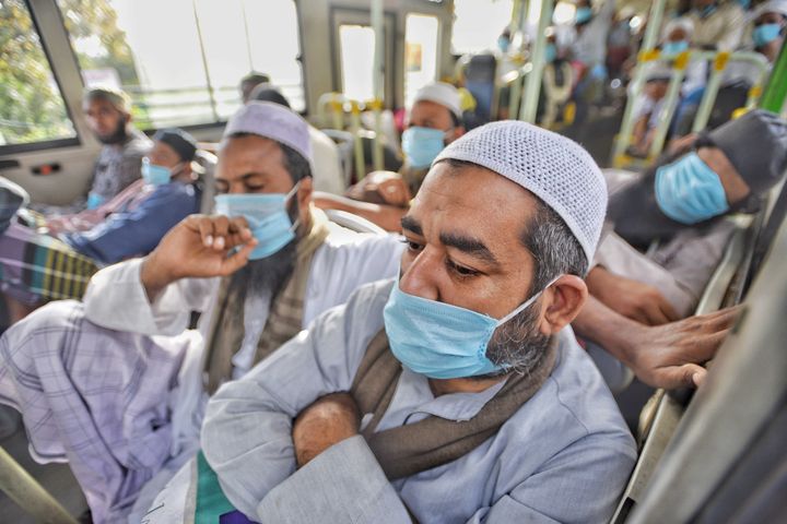 People who took part in a Tablighi Jamaat function earlier this month aboard buses taking them to a quarantine facility amid concerns of infection, on day 7 of the 21-day nationwide lockdown imposed by PM Narendra Modi to check the spread of coronavirus, at Nizamuddin West on March 31, 2020 in New Delhi.