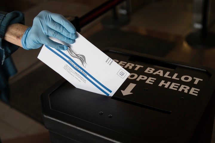 A voter casts a mail-in ballot at a drop box in West Chester, Pennsylvania, in May.