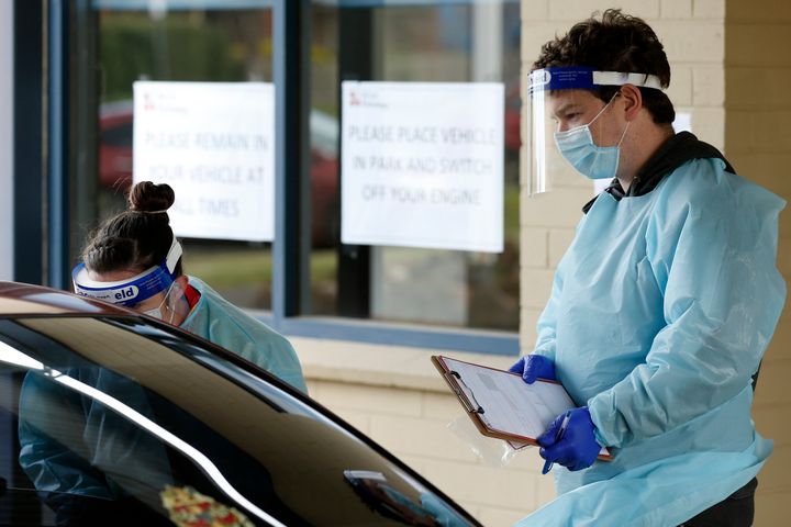 Medical professionals perform COVID testing at a drive through clinic on August 21, 2020 in Ballarat, Australia. 