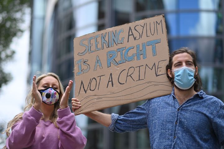 Protesters carry a placard at a demonstration to highlight conditions inside Brook House immigration removal centre, outside the Home Office in London 