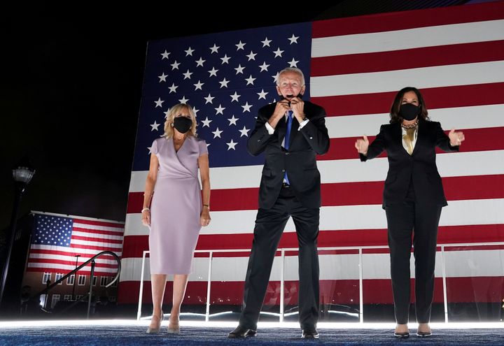 Democratic presidential nominee Joe Biden, flanked by his wife Jill (left) and Sen. Kamala Harris of California, his ticket's vice presidential candidate, celebrate on a stage in Delaware at the end of last week's virtual national convention.