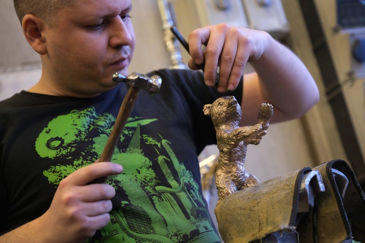 Artisan Timur Hepting works on a Berlinale Film Festival bear trophy at the Hermann Noack Bildgiesserei foundry where the tro