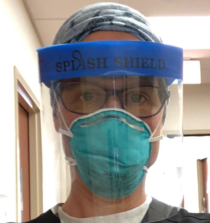 The author, shown wearing protective gear, returned to work in the emergency department of her hospital on July 3, 2020.