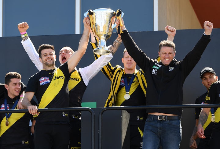 MELBOURNE, AUSTRALIA - SEPTEMBER 29: Tigers head coach Damien Hardwick and Trent Cotchin of the Tigers show the Premiership Trophy to the crowd during the Richmond Tigers Post AFL Grand Final Celebrations at Punt Road Oval on September 29, 2019 in Melbourne, Australia. The Richmond Tigers beat the Greater Western Sydney Giants in yesterday's AFL Grand Final. (Photo by Quinn Rooney/Getty Images)