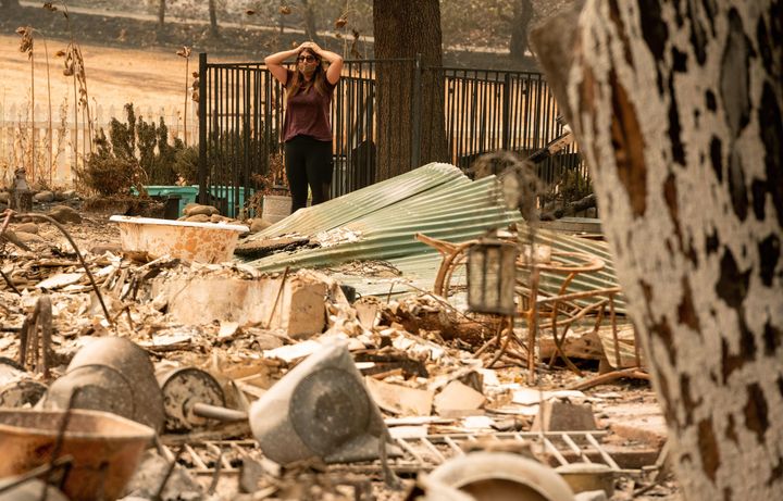 Alyssa Medina reacts to the charred remains of her family home, burned by the LNU Lightning Complex fire in Vacaville, California, on Aug. 23, 2020.