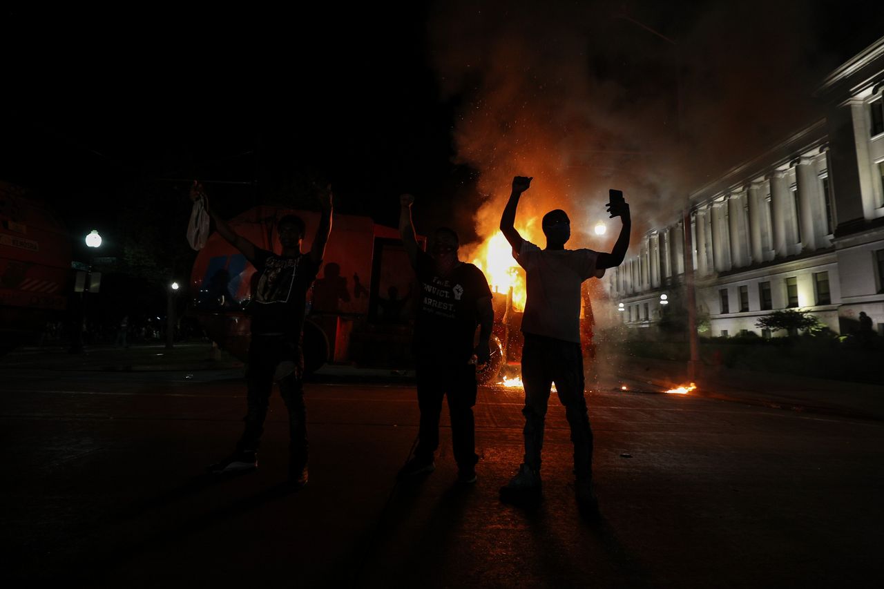 Protesters in response to the police shooting of Jacob Blake light a cleaning truck on fire in Kenosha, Wisconsin, on Aug. 24.