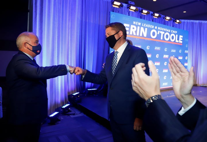 Conservative Leader Erin O'Toole gives former leader Andrew Scheer a fist-bump after his leadership election win in Ottawa on Aug. 24, 2020. 