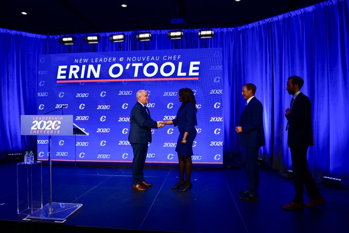 Newly elected Conservative leader Erin O'Toole shakes hands with his fellow candidates Leslyn Lewis, Peter MacKay and Derek Sloan after his victory speech in Ottawa on Aug. 24, 2020.