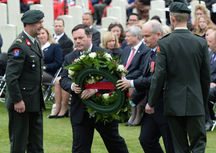 Then-Minister of Defence Jason Kenney and then-Minister of Veterans Affairs Erin O'Toole place a wreath during a commemorative ceremony at Holten Canadian War Cemetery in Holten, Netherlands, on May 4, 2015.