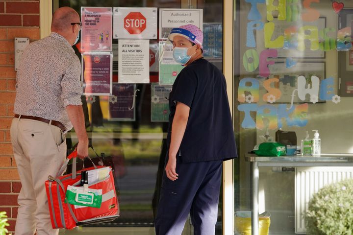 Members of the medical personnel are seen outside the Florence Aged Care Facility amid the second wave of the coronavirus disease (COVID-19) in Melbourne, Australia August 17, 2020. REUTERS/Sandra Sanders