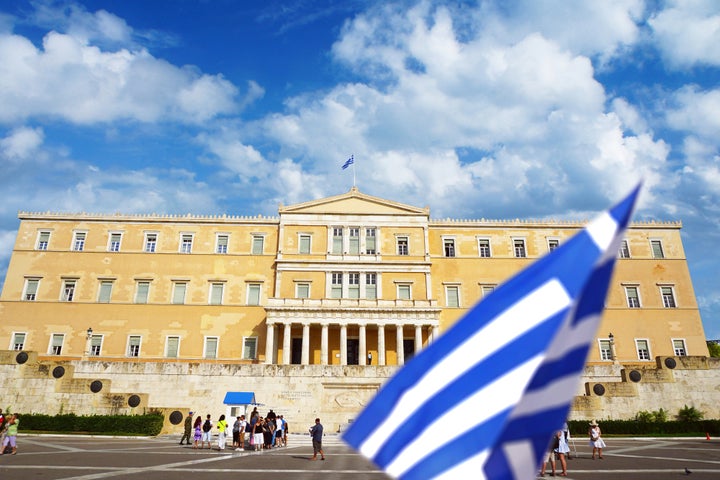 Athens, Greece - September 9, 2016: People walk around the Greece parliament on Syntagma square on summer sunny day in Athens.