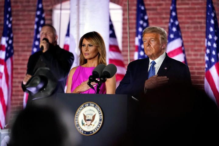 President Donald Trump and first lady Melania Trump stand as Trace Adkins sings the National Anthem on the third day of the Republican National Convention.