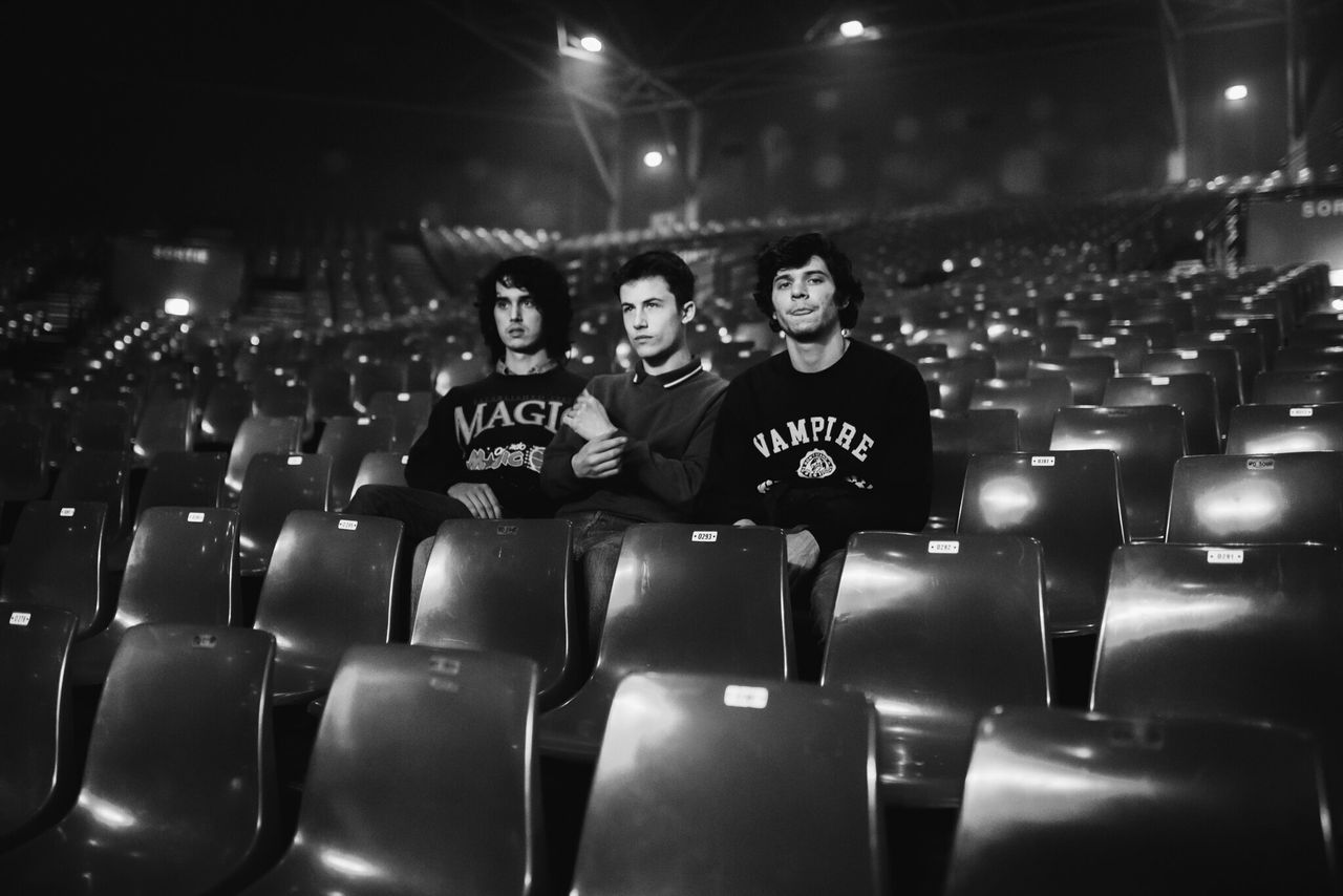 Wallows band members Cole Preston, Dylan Minnette and Braeden Lemasters in an empty theater. 