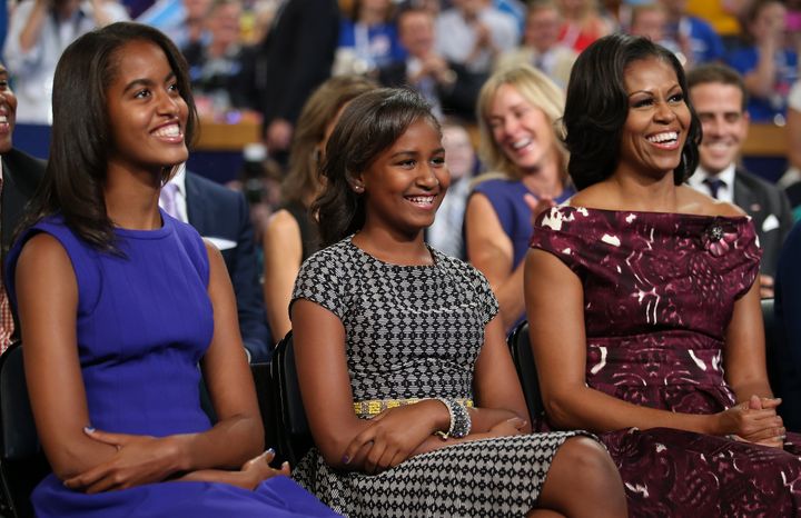 Malia, Sasha and Michelle Obama listen as then-President Barack Obama speaks at the Democratic National Convention in 2012.