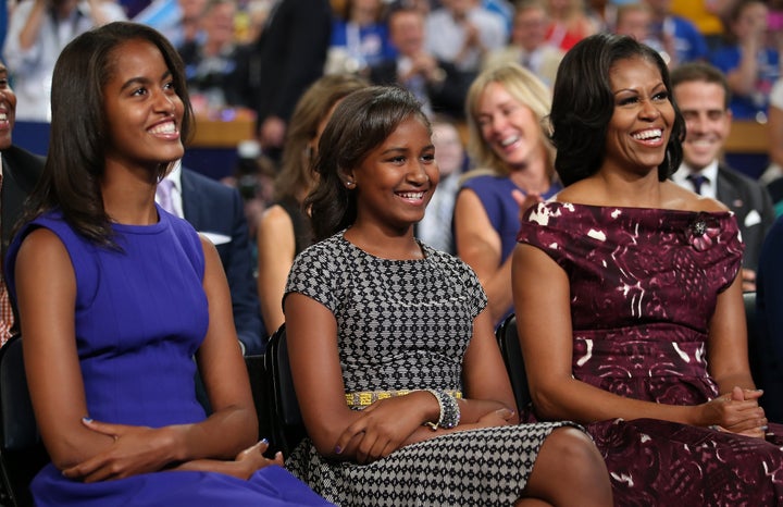 Malia, Sasha and Michelle Obama listen as then-President Barack Obama speaks at the Democratic National Convention in 2012.