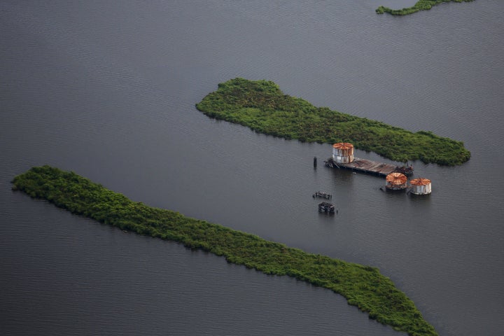 Old oil tanks are seen in an area affected by Hurricane Katrina on the Mississippi River delta.