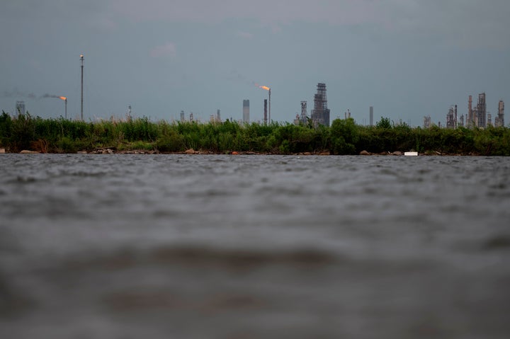 An oil and gas plant is seen across the Bayou Contraband as the water starts to rise before the arrival of Hurricane Laura in Lake Charles, Louisiana.