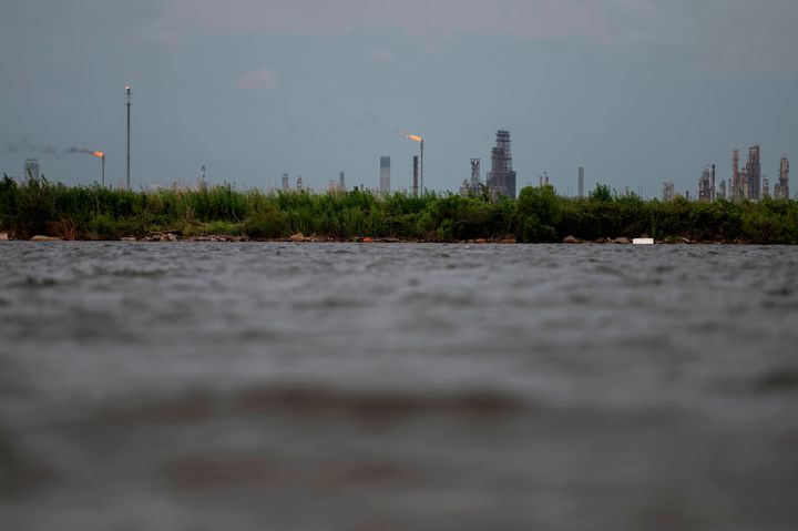 An oil and gas plant is seen across the Bayou Contraband as the water starts to rise before the arrival of Hurricane Laura in