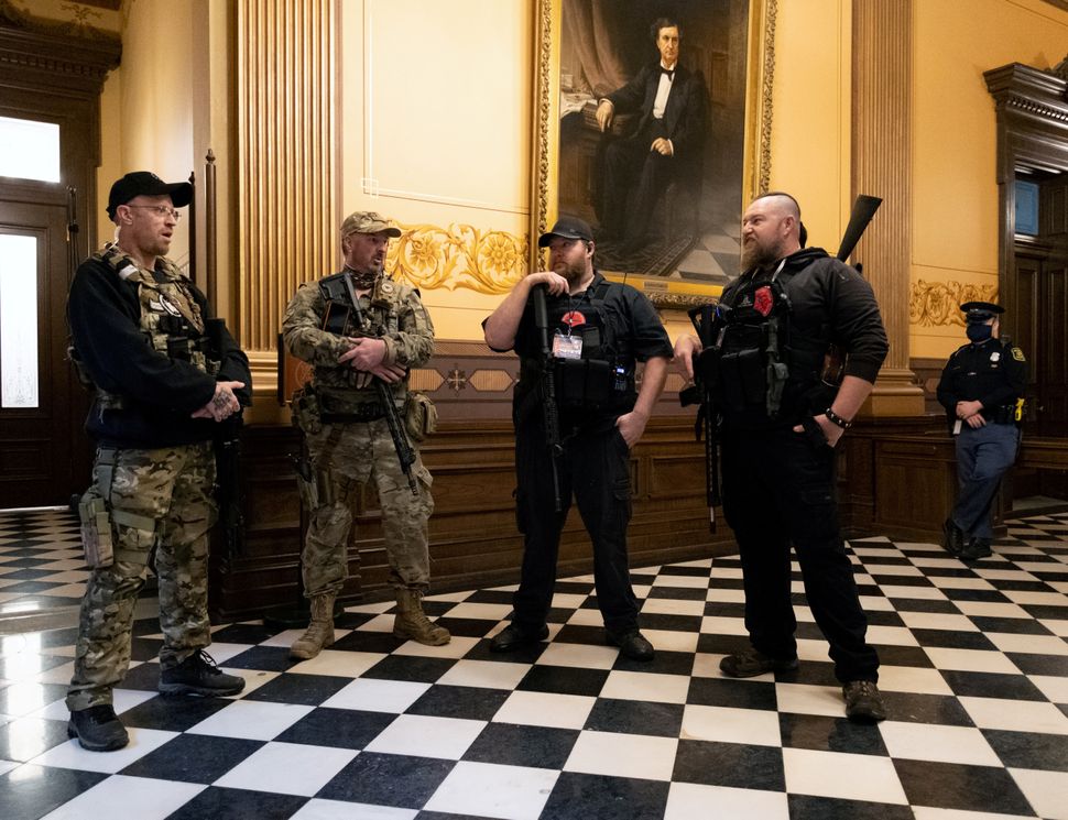 Armed members of a militia group gather at Michigan's Capitol building in April ahead of a vote on the extension of Gov. Gretchen Whitmer's emergency declaration/stay-at-home order due to the coronavirus.
