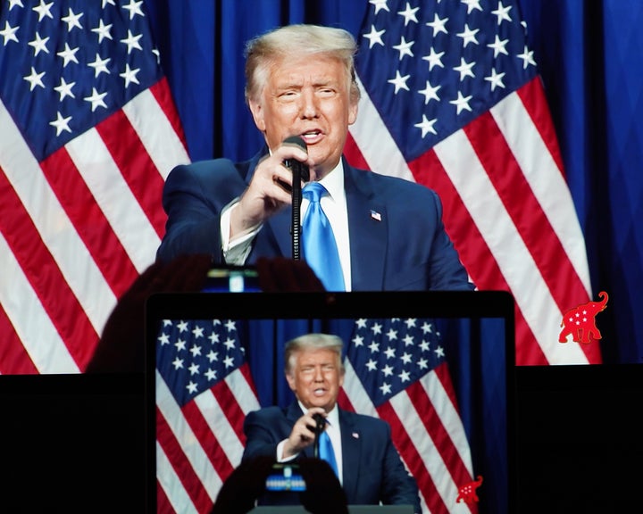 Screens display President Donald Trump speaking Monday during the 2020 Republican National Convention, after he was nominated for a second term. The convention is being held mostly virtually because of the coronavirus pandemic.