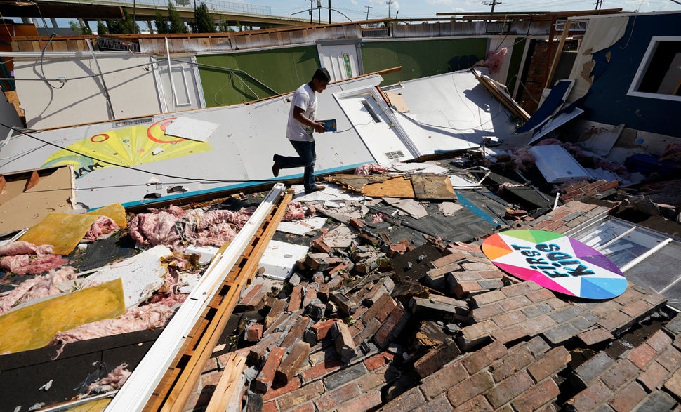 Benjamin Luna helps recover items from the children's wing of the First Pentecostal Church that was destroyed by Hurricane La