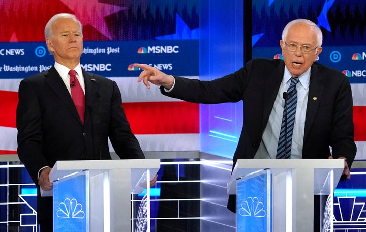 Sen. Bernie Sanders (I-Vt.), right, criticized Joe Biden for signing off on trade deals that cost the U.S. manufacturing jobs