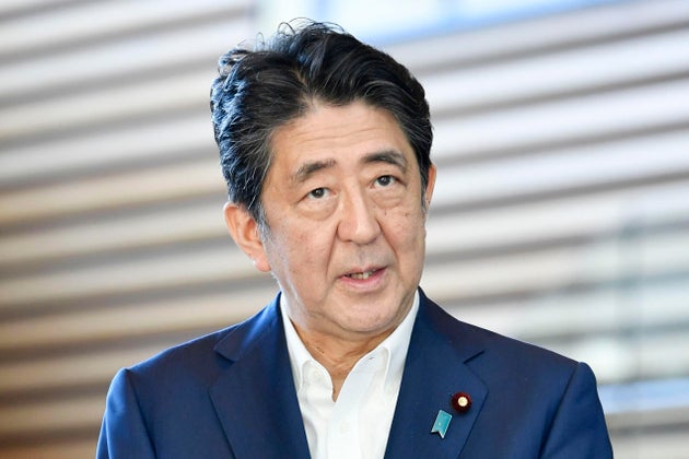 Japanese Prime Minister Shinzo Abe answers journalists' questions at his official residence on August...