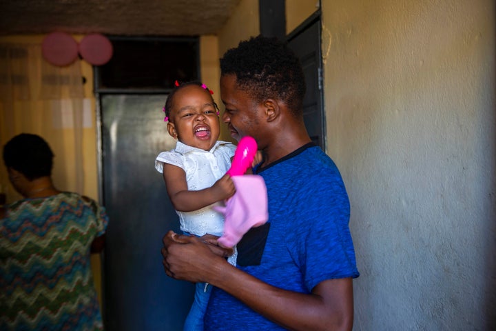 Verty holds up his 1-year-old daughter at his house in Port-au-Prince, Haiti, on Aug. 25, 2020. Verty says government contrac