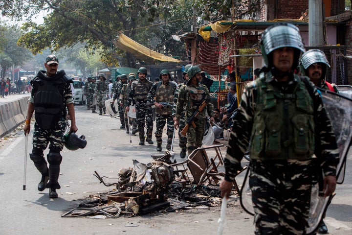 Security personnel patrol along a street following riots, at Mustafabad area in New Delhi on February 28, 2020. 