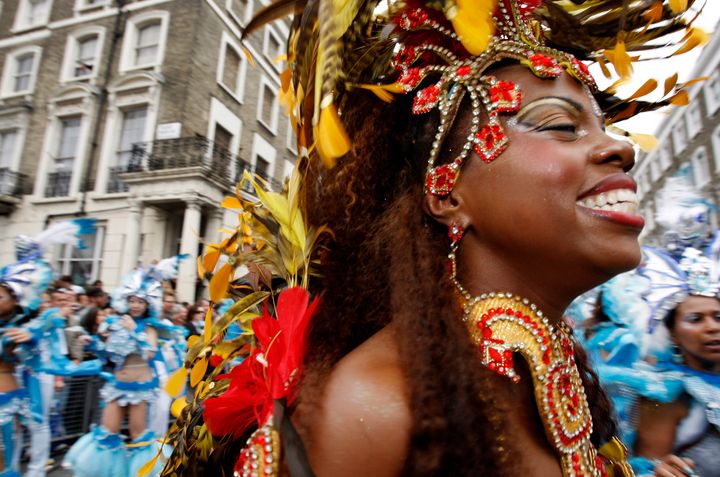 A performer dances in the street parade at the annual Notting Hill Carnival in central London, August 25, 2008. REUTERS/Suzanne Plunkett (BRITAIN)