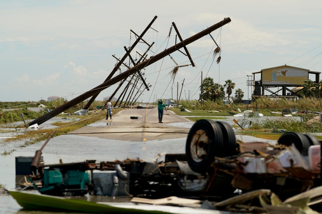 People survey the damage left in the wake of Hurricane Laura on Thursday, August 27, 2020, in Holly Beach, Louisiana.